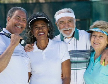 2 happy couples in 55 plus community on the tennis court